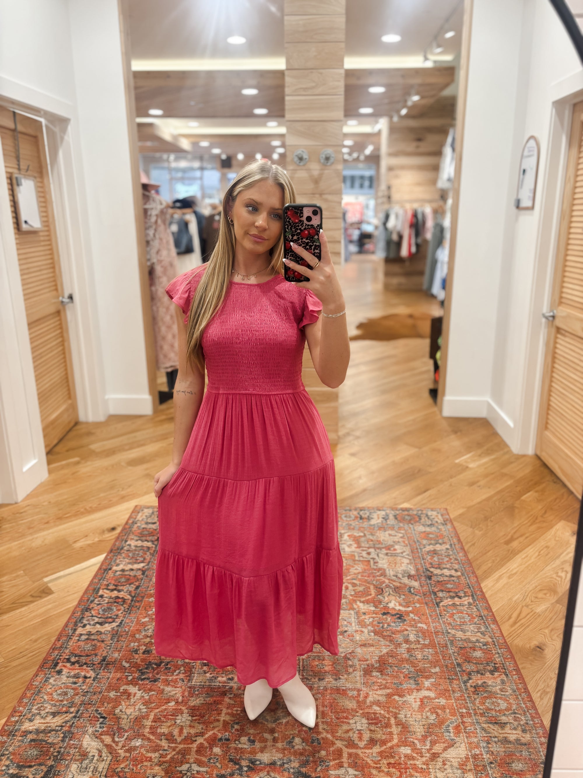 The Londyn Midi Dress in a stunning dusty fuschia hue features a round neckline with a stylish behind the neck button and keyhole, short cap sleeves, and a flattering smocked body. The tiered skirt adds volume and movement to the midi length, while the lining ensures comfort. Made with a soft blend of 62% rayon and 38% polyester, with a 100% polyester lining. Elevate any occasion with this versatile and chic dress. Boutique style Ashland, Kentucky 