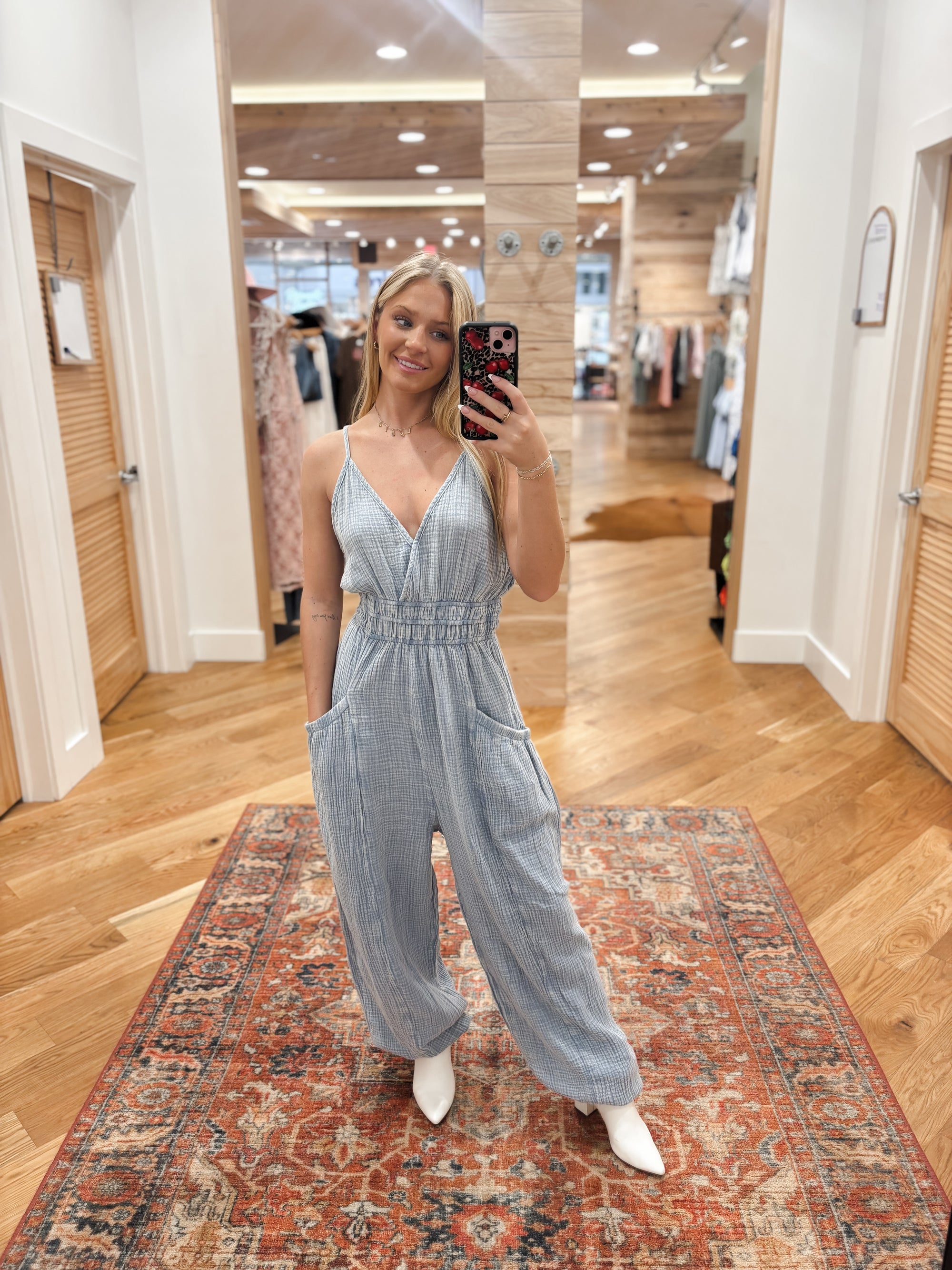 Expertly crafted from mineral washed cotton gauze, the Easy Days Denim Blue Jumpsuit offers a sophisticated yet casual look. The sleeveless design and adjustable straps provide a comfortable fit, while the deep V-neck and elastic waist add a touch of elegance. With side pockets for added convenience, this jumpsuit is perfect for any easy day. Boutique style Ashland, Kentucky 