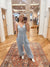 Expertly crafted from mineral washed cotton gauze, the Easy Days Denim Blue Jumpsuit offers a sophisticated yet casual look. The sleeveless design and adjustable straps provide a comfortable fit, while the deep V-neck and elastic waist add a touch of elegance. With side pockets for added convenience, this jumpsuit is perfect for any easy day. Boutique style Ashland, Kentucky 