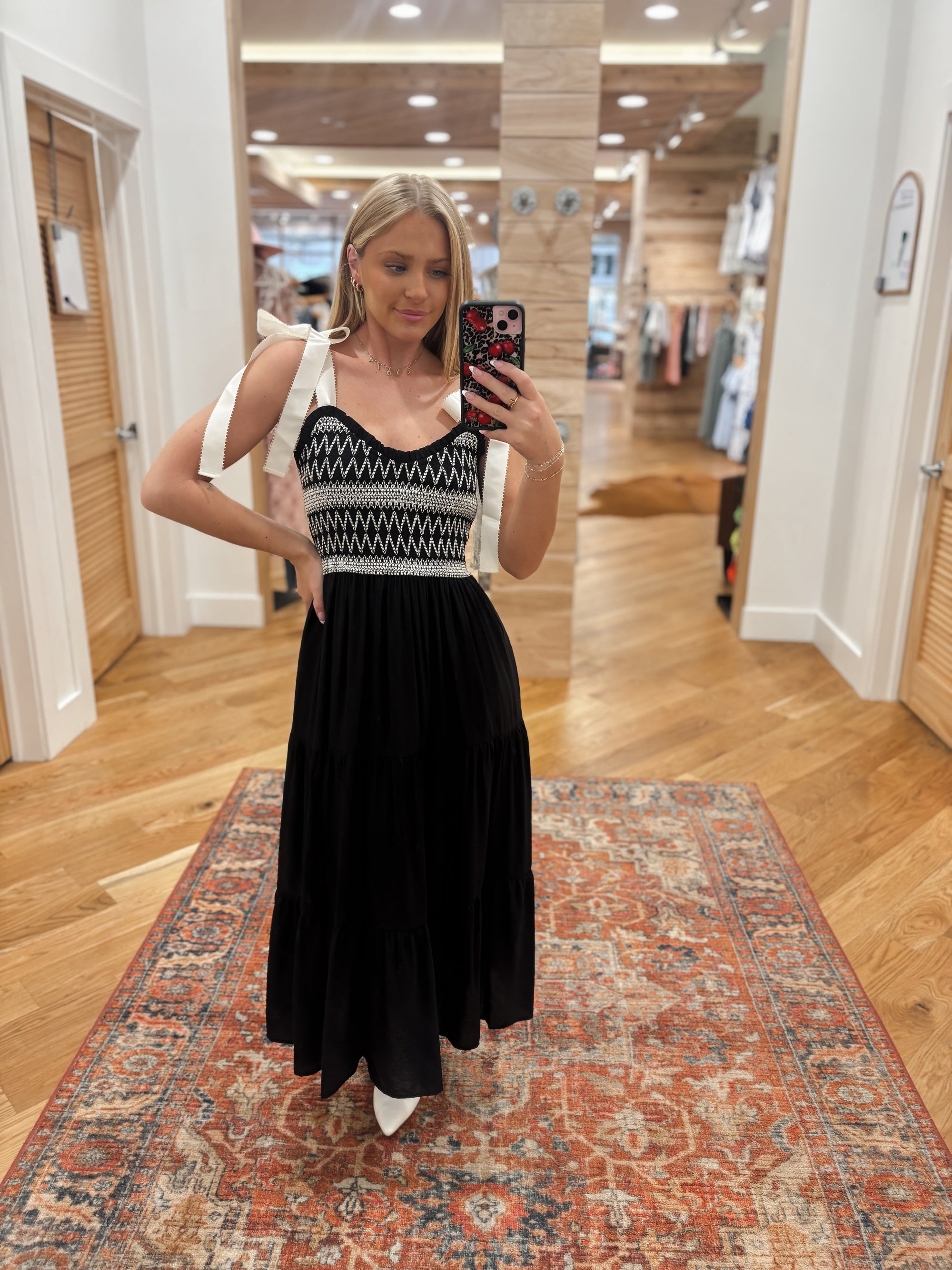 Upgrade your wardrobe with the Tied Intentions Black Maxi Dress! This stunning maxi dress features a flattering sweetheart neckline and sleeveless design, perfect for any occasion. The ribbon tie strap and smocked bodice with embroidery detail add a charming touch, while the contrast detailing adds a pop of style. Made with a soft and lightweight rayon-nylon blend shell and fully lined with 100% polyester, this dress will keep you comfortable and stylish all day long. Boutique style Ashland, Kentucky 