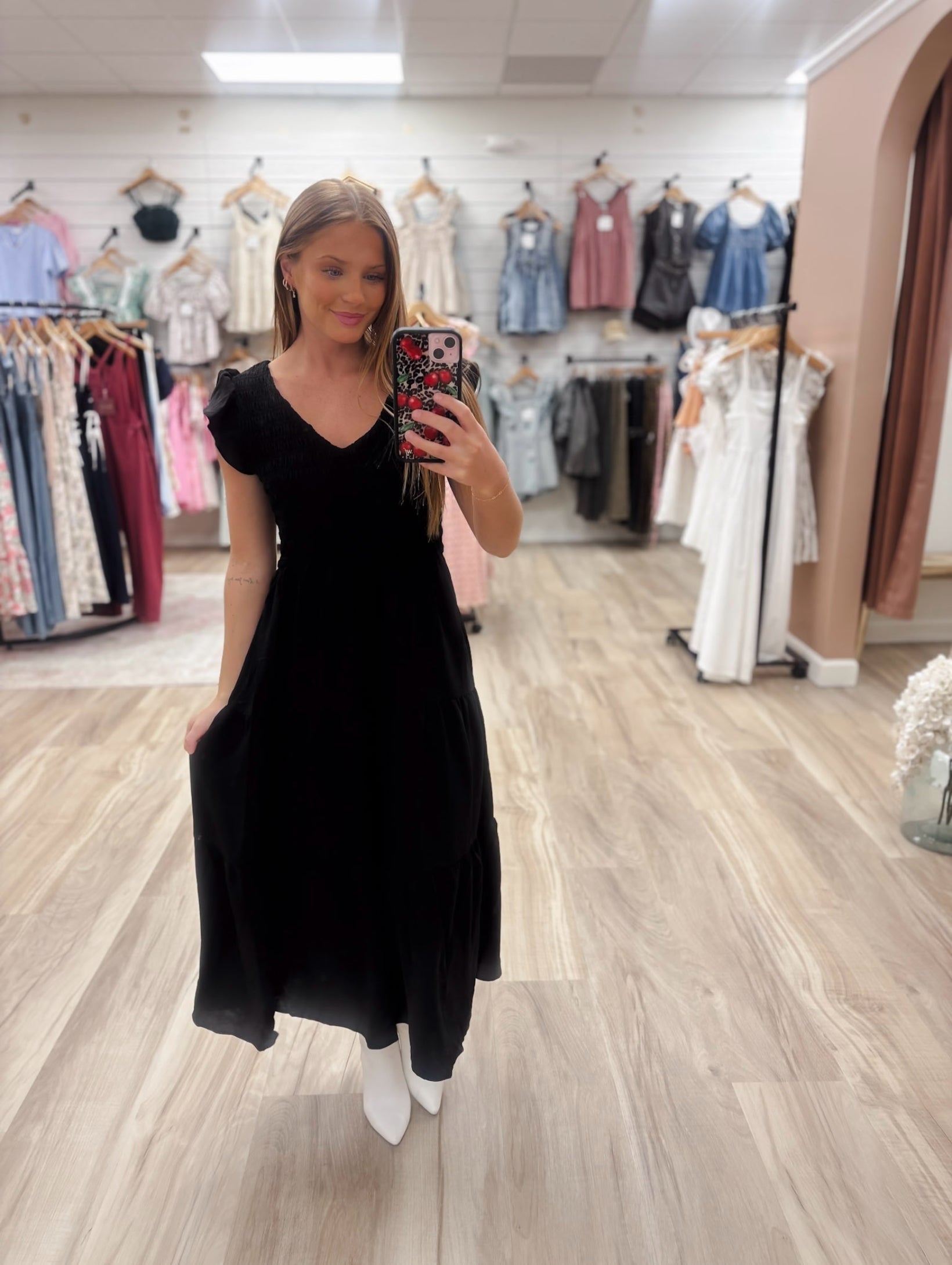 The Bethany Black Dress features a mint v neckline and flutter mini sleeves, along with a smocked bodice and tiered midi skirt for added style and comfort. Made with 100% polyester shell and lining, this dress is perfect for any occasion. Boutique style Ashland, Kentucky 