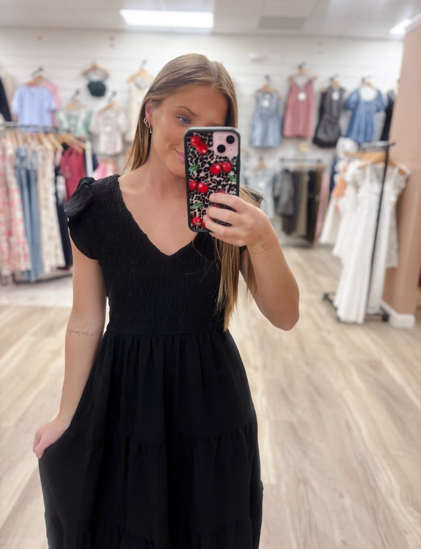 The Bethany Black Dress features a mint v neckline and flutter mini sleeves, along with a smocked bodice and tiered midi skirt for added style and comfort. Made with 100% polyester shell and lining, this dress is perfect for any occasion. Boutique style Ashland, Kentucky 